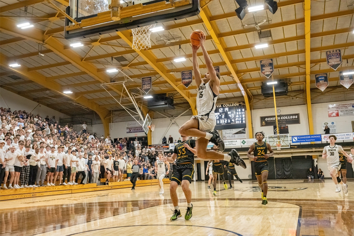 Geneva College Basketball player dunking